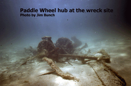 The hub of the Paddle Wheel is amoung the scattered wreckage of the Mountaineer site.  Photo by Jim Bunch